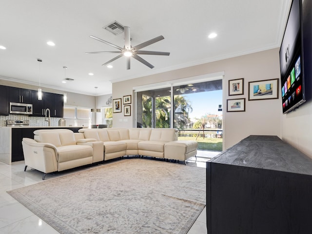 living room with ceiling fan and ornamental molding