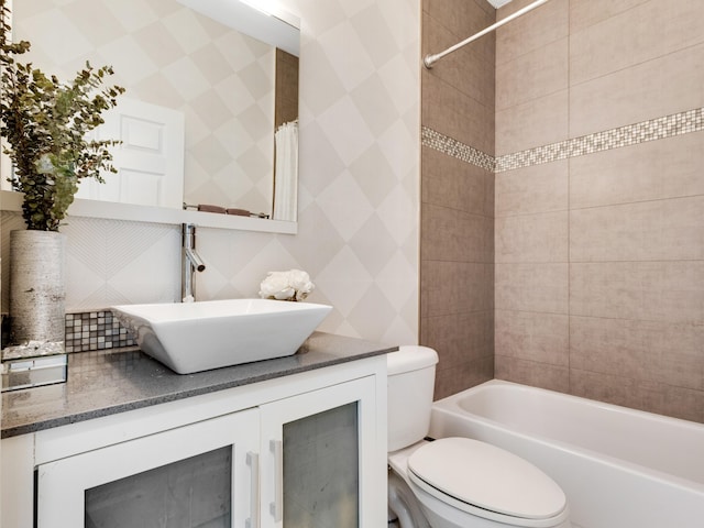 full bathroom featuring vanity, backsplash, shower / bath combo, and toilet