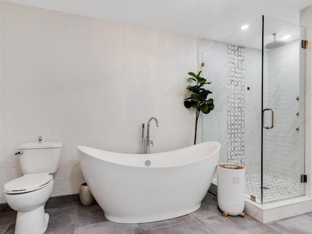 bathroom with tile patterned floors, toilet, and shower with separate bathtub