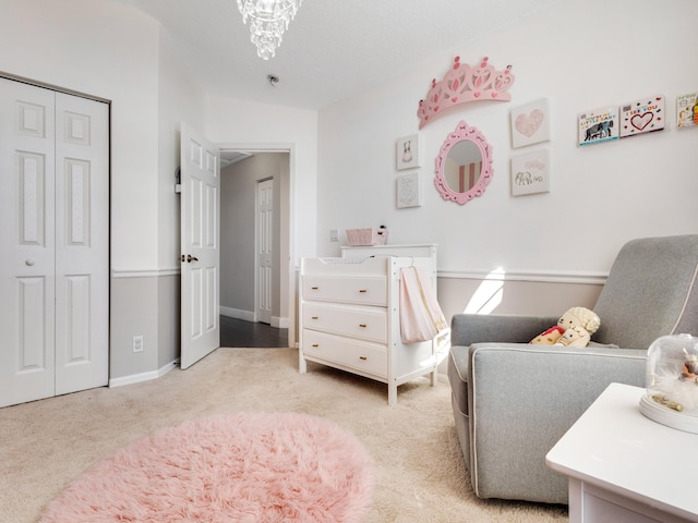 bedroom with light carpet, a notable chandelier, and a closet