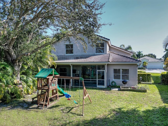 back of property with a playground and a lawn