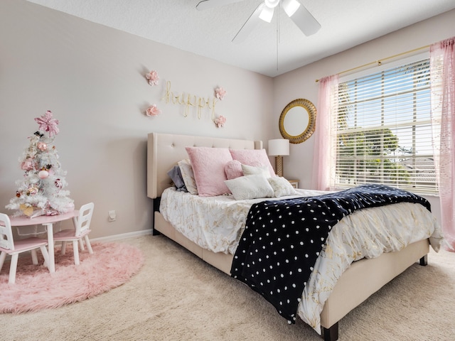 bedroom with light carpet, a textured ceiling, and ceiling fan