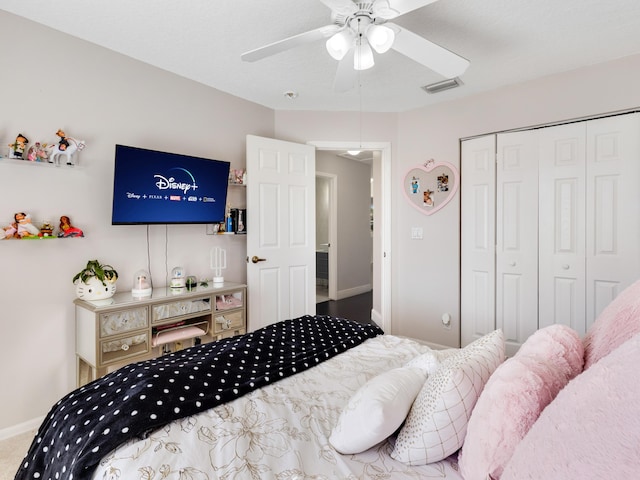 bedroom with ceiling fan and a closet