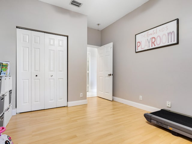 exercise room featuring light hardwood / wood-style flooring