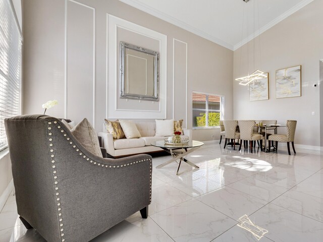 living area with ornamental molding and a towering ceiling