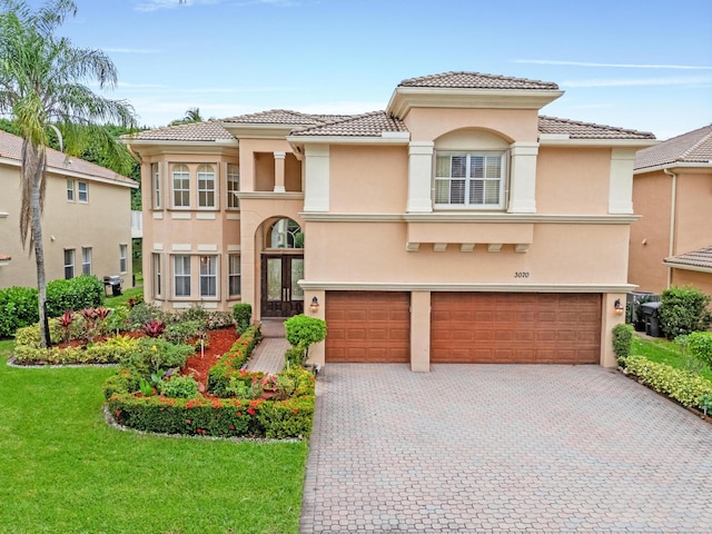 mediterranean / spanish home featuring french doors and a garage