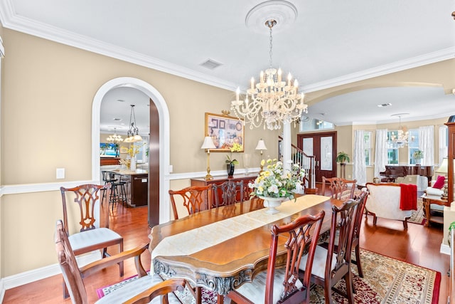 dining space featuring hardwood / wood-style flooring and crown molding