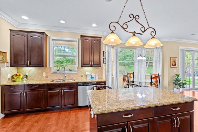 kitchen featuring dark hardwood / wood-style flooring, crown molding, sink, pendant lighting, and dishwasher