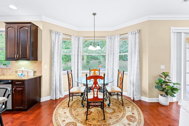 dining space with a healthy amount of sunlight, dark hardwood / wood-style flooring, ornamental molding, and a chandelier