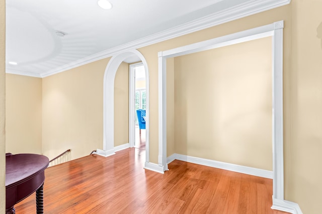 interior space with light wood-type flooring and crown molding