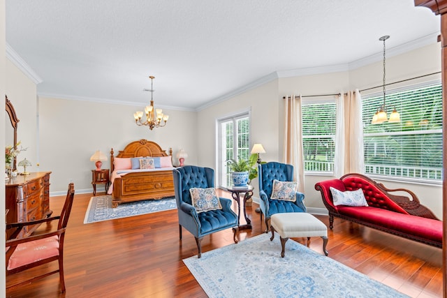 bedroom featuring a textured ceiling, a notable chandelier, ornamental molding, and dark wood-type flooring