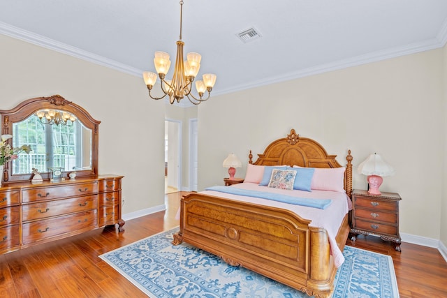 bedroom featuring ornamental molding, a notable chandelier, and hardwood / wood-style flooring