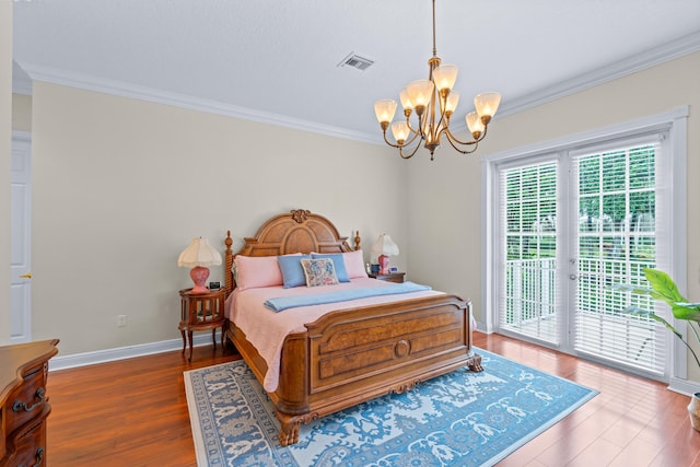 bedroom with access to exterior, crown molding, dark hardwood / wood-style flooring, and a notable chandelier