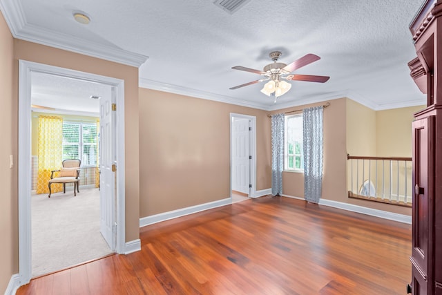 unfurnished room featuring a textured ceiling, plenty of natural light, and dark hardwood / wood-style floors