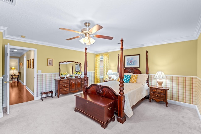 bedroom featuring carpet, ceiling fan, and crown molding