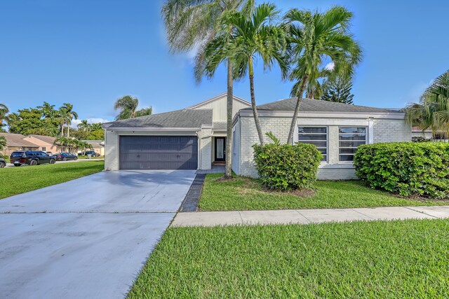 ranch-style home with a front yard and a garage