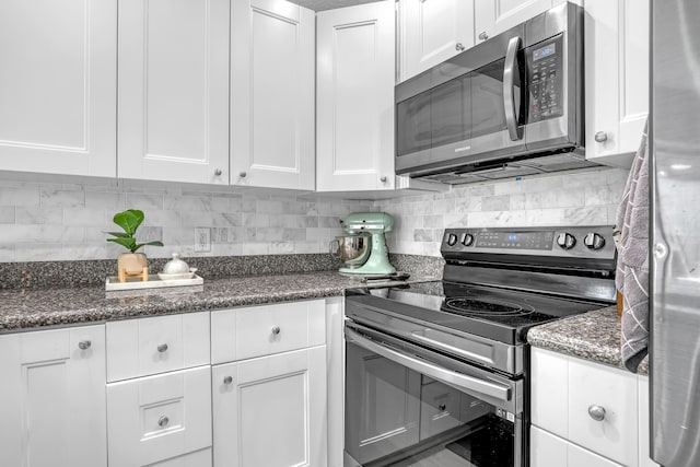 kitchen featuring white cabinets, appliances with stainless steel finishes, and tasteful backsplash