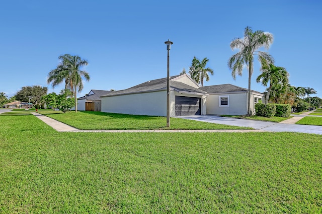 single story home featuring a garage and a front yard