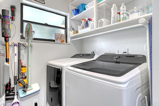 clothes washing area with washer and clothes dryer