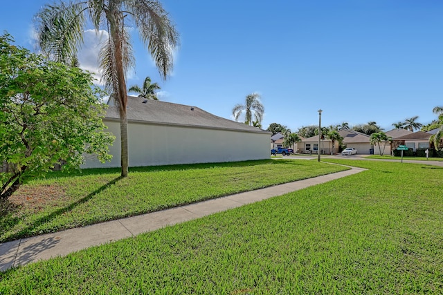 view of side of home featuring a lawn