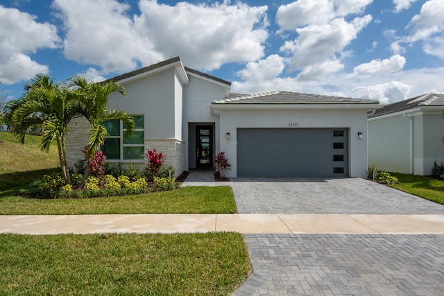 view of front of house with a front yard and a garage