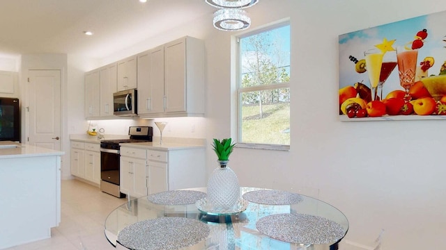 kitchen featuring white cabinets, stainless steel appliances, and a wealth of natural light