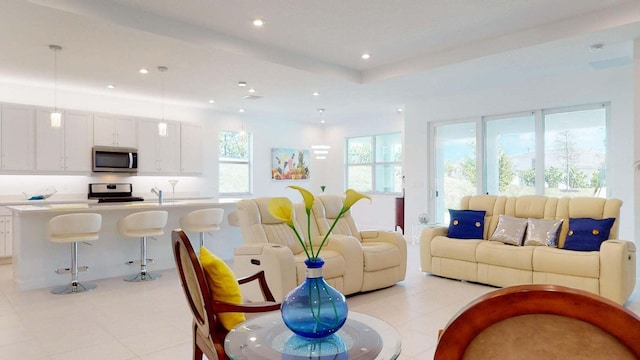 living room featuring sink and a wealth of natural light