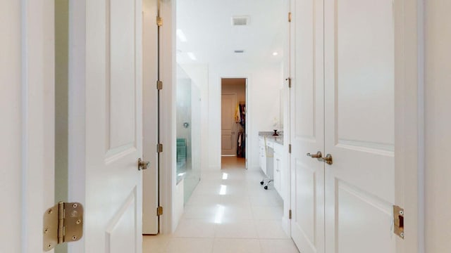 hall featuring light tile patterned floors