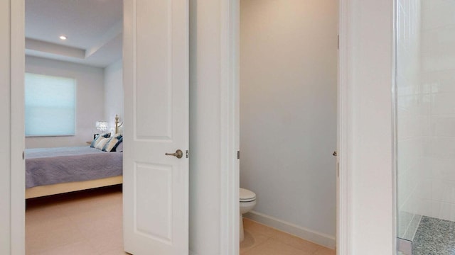 bathroom featuring a shower and toilet