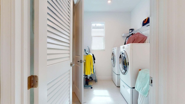 laundry room featuring light tile patterned flooring and washing machine and clothes dryer