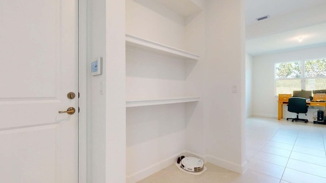 clothes washing area featuring light tile patterned floors