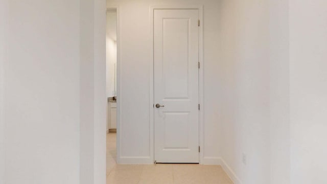 corridor with light tile patterned floors