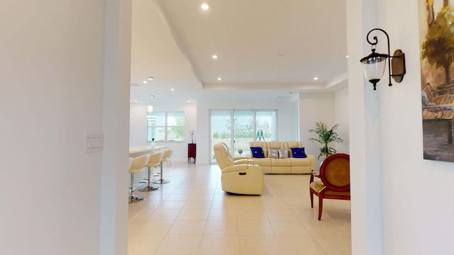 tiled living room with a tray ceiling