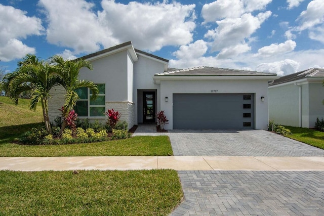 view of front of house with a garage and a front yard