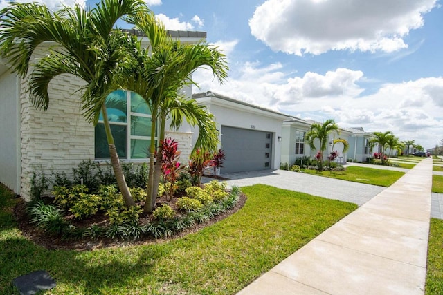 single story home with a front lawn and a garage