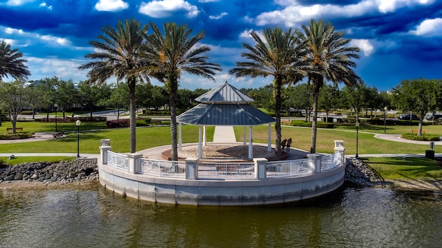 view of community with a gazebo, a water view, and a lawn