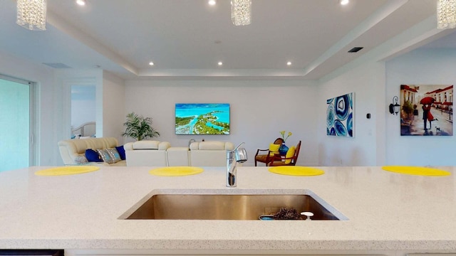 kitchen featuring sink and a tray ceiling