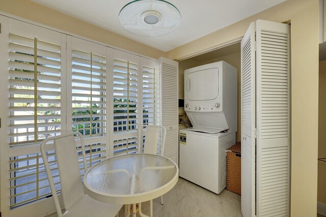 laundry area with stacked washer / drying machine