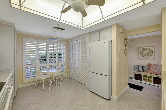 kitchen with white cabinets, white refrigerator, ceiling fan, and stainless steel range oven