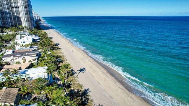 drone / aerial view featuring a water view and a beach view