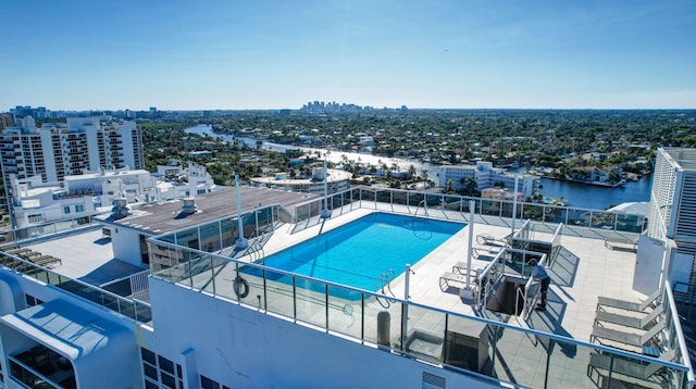 view of swimming pool featuring a water view