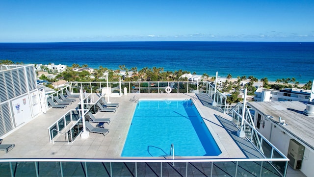 view of swimming pool featuring a water view