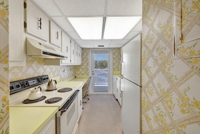 kitchen featuring white cabinetry, a drop ceiling, light carpet, and white appliances