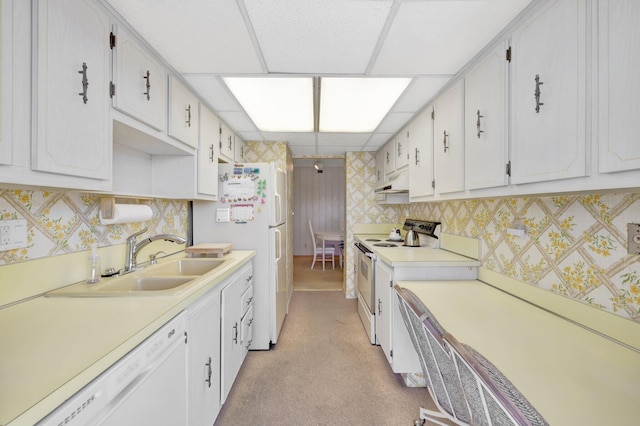 kitchen featuring white cabinets, white appliances, sink, and light carpet