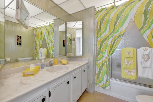 full bathroom featuring combined bath / shower with glass door, vanity, and toilet