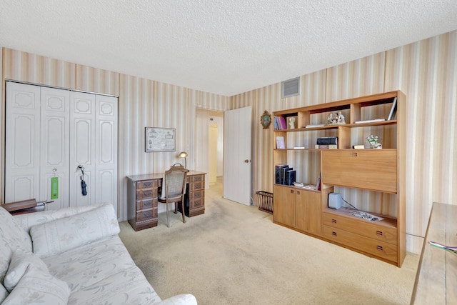 office with a textured ceiling and light carpet