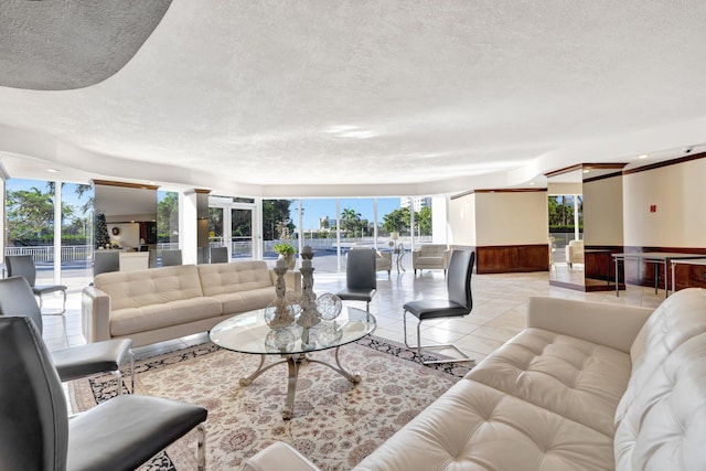 living room featuring light tile patterned floors and a textured ceiling