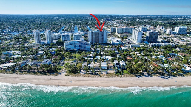 bird's eye view featuring a water view and a view of the beach