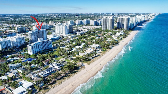 birds eye view of property featuring a water view and a view of the beach