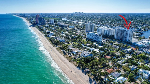 birds eye view of property with a beach view and a water view